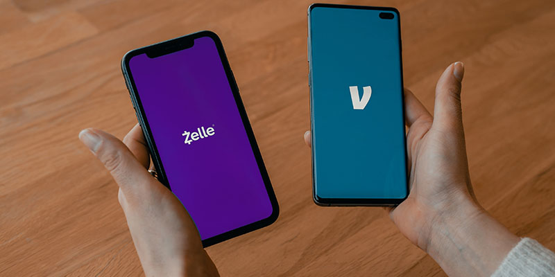 Person holding two Android smartphones