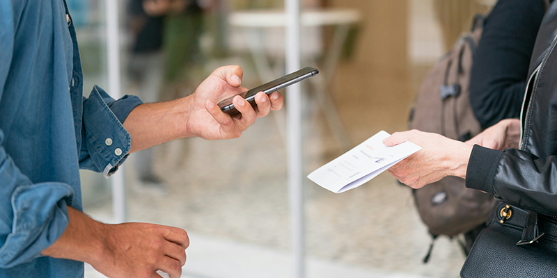 A man scanning a QR code using his phone