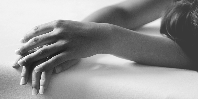 A black and white image of a model showing her hands