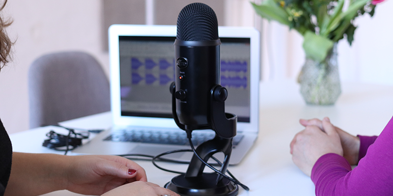 Two women recording a podcast